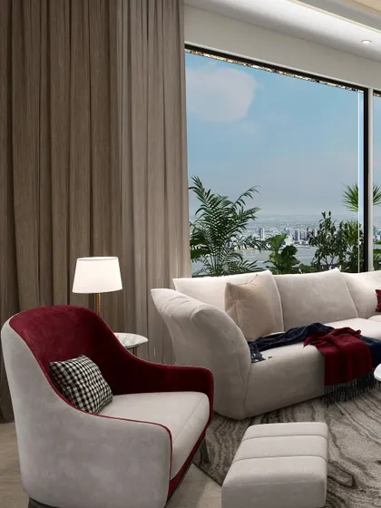 In this living room, a predominantly neutral palette is enlivened by carefully placed accents of deep red. A custom two-tone armchair and throw pillows introduce color and warmth without disrupting the overall sense of calm.