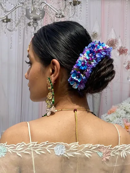 A side profile of the bride, showcasing her elegant floral updo.