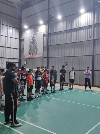 My coaches and I addressing a group of students on the court. I use these opportunities to share knowledge, build team spirit, and motivate my players.