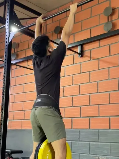 Getting ready for a weighted pull-up. This exercise is a pure test of relative strength.
