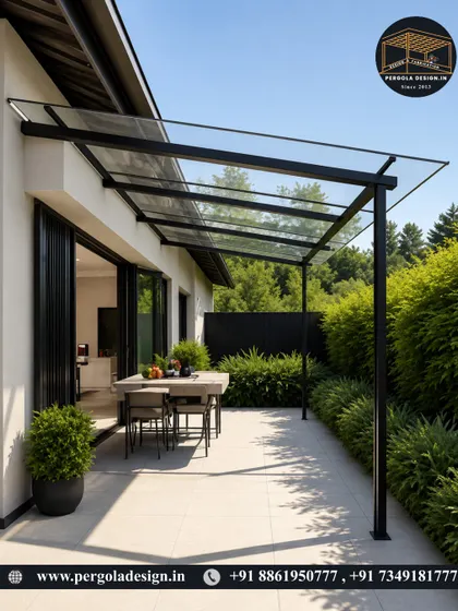 A closer look at the sleek design of a glass canopy. The slim black frame and transparent roof create a modern and unobtrusive shelter, perfect for patios and outdoor dining areas.
