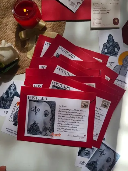 A stack of postcards ready to be sent out, each enclosed in a vibrant red envelope. Gifting words and art is a special feeling.