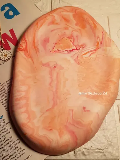 An empty view of the orange and pink marble cloud tray, showing off its unique, abstract pattern.