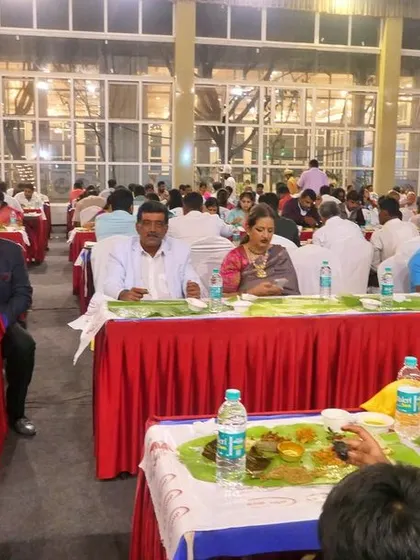 A candid shot of guests seated for a traditional meal. I focus on creating an environment where the food is the highlight of the celebration.
