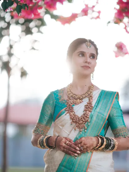 A beautifully backlit portrait of the bride, with the sun creating a soft halo effect around her, highlighting her radiant look.