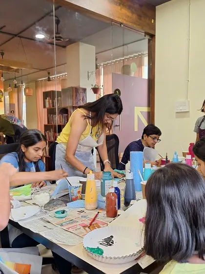 A group of participants at a tote bag painting workshop. I'm here to help guide and inspire, ensuring everyone has a great time.
