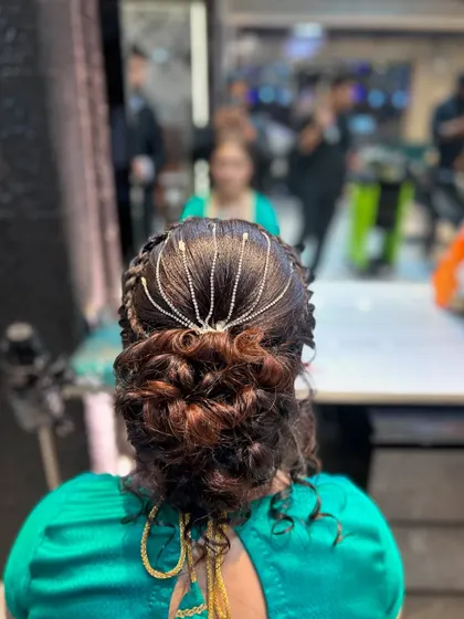A close-up of the finished messy bun with the beautiful hair accessory. This style is intricate yet looks effortlessly chic.