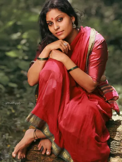 A rustic, village-themed series inspired by the movie 'Kanthara'. The model is styled in a simple red saree, captured in a natural, watery landscape to evoke a sense of raw, earthy beauty.