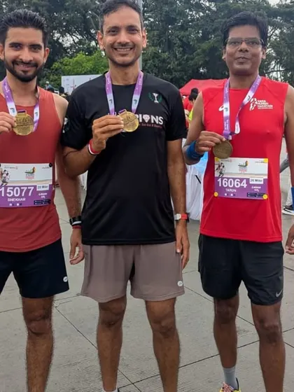 Posing with their finisher medals after a great race. Every member's success is a win for the entire Champions tribe.