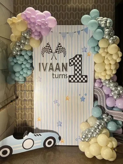 A welcome sign and photo op spot for a 'Fast One' car-themed birthday. The pastel colors give a softer, modern feel to the classic racer theme.