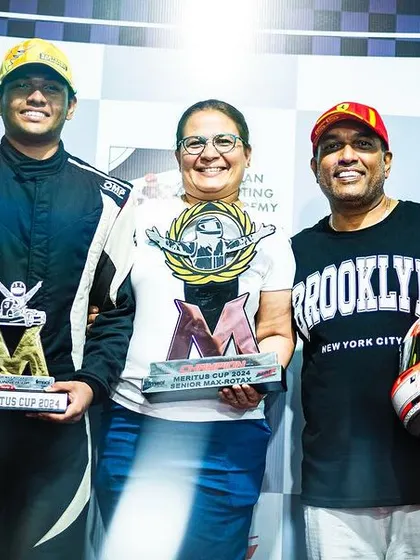 A proud family moment on the podium. We believe that family support is a crucial part of a young driver's journey, and we celebrate their victories together.