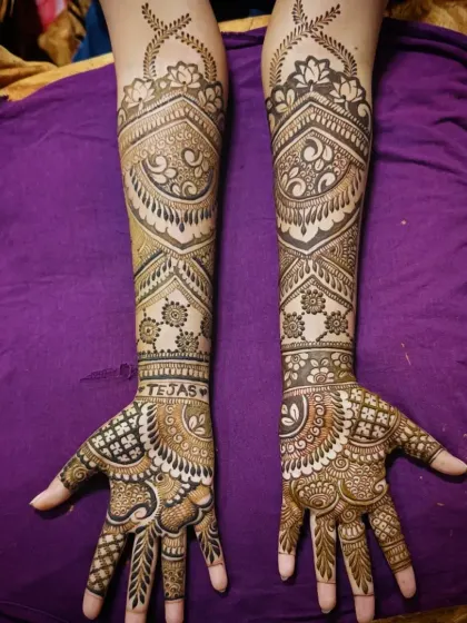 This is an example of my intricate full-arm mehandi work. The design features a mix of delicate paisleys, bold geometric bands, and fine line work, creating a stunning and balanced look perfect for any grand celebration.