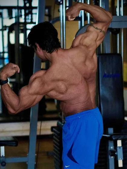 Discipline gives you freedom. A back double biceps pose that shows the liberating power of a structured and disciplined lifestyle.