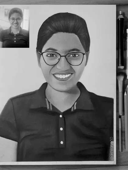 A smiling portrait of a young woman with glasses, drawn on A4 paper. This black and white sketch has a friendly and approachable feel, captured with graphite pencils.