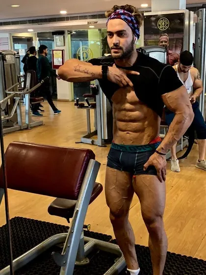 Checking the abs. A defined core is a sign of low body fat and a disciplined diet, which are key components of my coaching.