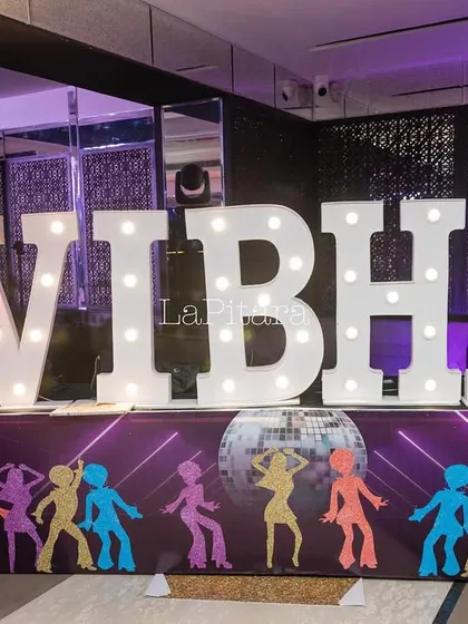 Large marquee letters spelling out the birthday girl's name, 'VIBHA', serving as a bold and bright decor element.