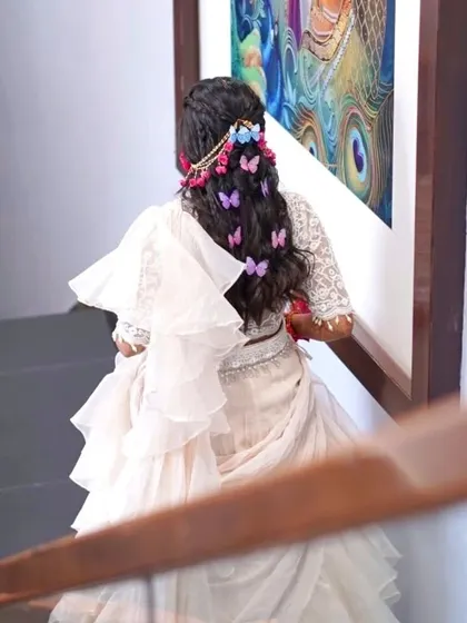 A look at the whimsical butterfly and floral hairstyle we created for her Haldi.