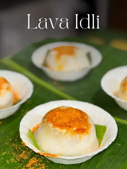 A serving of my Lava Idlis, ready to surprise your guests. Each one is dusted with spicy podi powder, hinting at the warm sambar waiting inside.