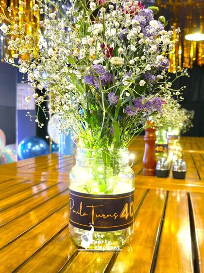 Another view of the light-up centerpiece, showing the custom 'Paula Turns 40' label that personalized the decor for the birthday girl.