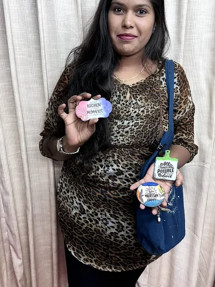 A participant proudly displaying the three unique magnets she created during our beginner-friendly workshop.