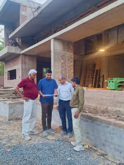 **Of Courtyards and Corners, Ahmedabad:** Our team on site, discussing plans. This project is a collaboration, and we believe in being present from the first sketch to the final brick, ensuring the vision is executed perfectly.