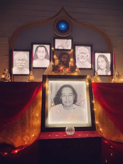 Our altar illuminated by fairy lights, creating a magical and devotional ambiance. The portraits of the masters seem to come alive, their blessings radiating out to all who are present.