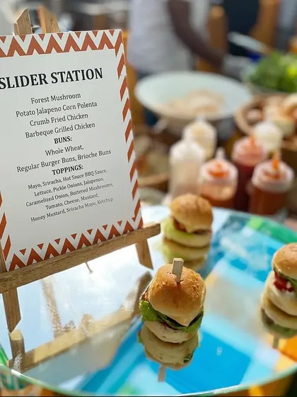 A mini slider station, a guaranteed crowd-pleaser at any kids' party. We offer different patties like crumb-fried chicken and forest mushroom, with a variety of buns and toppings.