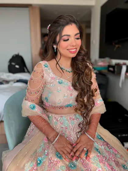 Eyes closed, this shot highlights the soft pink and blue shimmer on her eyelids, perfectly matching her lehenga.