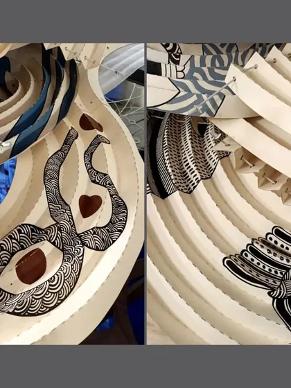 A detailed close-up of the Gond art and origami collaboration with Ankon Mitra. This image reveals the hand-painted Gond motifs by artist Venkat Shyam, which are then transformed through complex 'Kalmon Chain' origami folds.