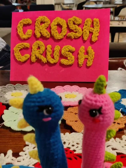 My brand sign, "Crosh Crush," with some dino plushies.