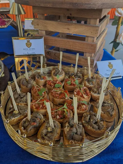 A platter of assorted bruschetta, featuring toppings like classic tomato and basil, and a savory mushroom mix. This is a versatile appetizer suitable for any event.