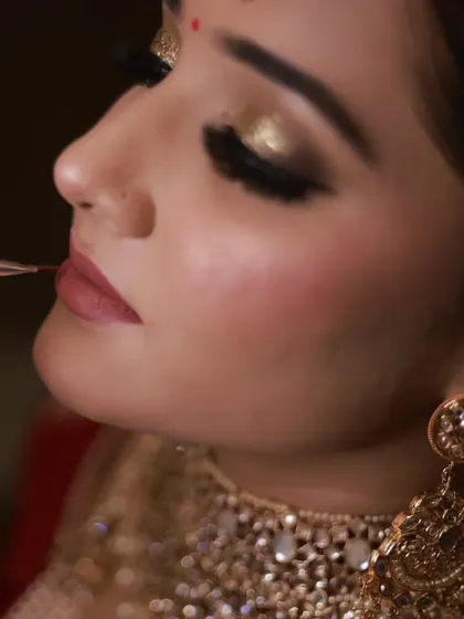 Another angle of the lip makeup application. This detailed work is crucial for achieving a crisp, professional finish on a bridal look.