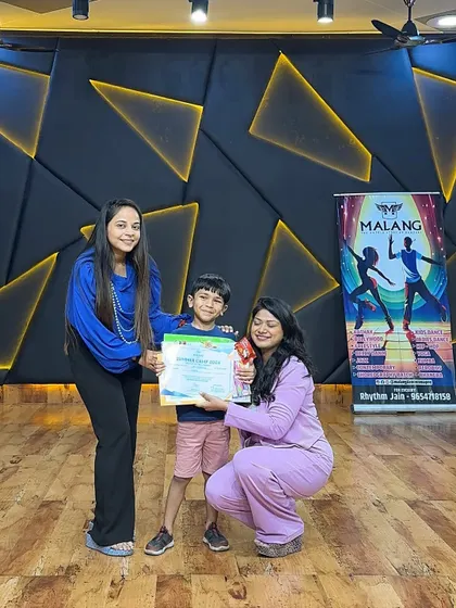 Another happy camper receiving his certificate and trophy. We believe in celebrating every achievement, big or small, to boost our students' confidence.