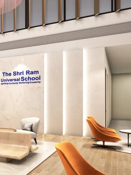The school's branding is seamlessly integrated into the architecture. The logo is placed on a pristine marble wall, flanked by vertical light grooves that draw the eye and add a touch of modern elegance to the lobby.