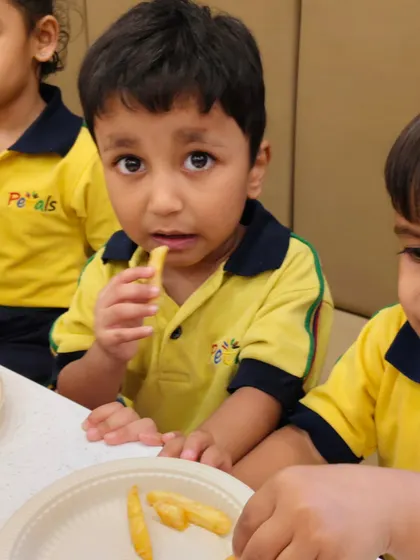 A student enjoying a plate of fries. Our food packages for school outings are designed to be both tasty and convenient.