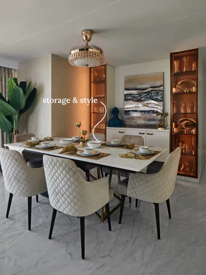 A dining room that balances storage and style, featuring an integrated crockery unit for elegance and practicality. The marble-top dining table and neutral chairs create a functional and beautifully composed setting.