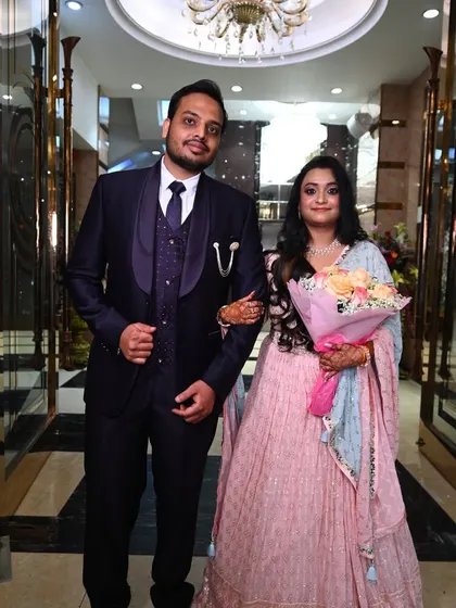 A classic portrait of a couple at their reception, with the bride holding a bouquet.