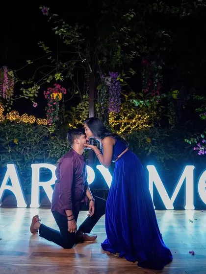 A grand proposal scene with "MARRY ME" light-up letters, creating a perfect pre-wedding moment.