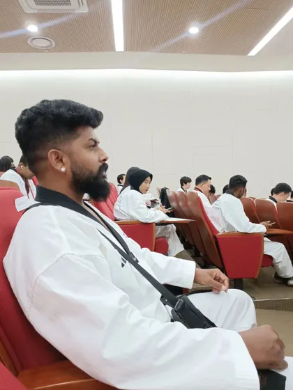 Focused during a lecture at the international Taekwondo partnership program. Continuous learning is key to being a great coach.