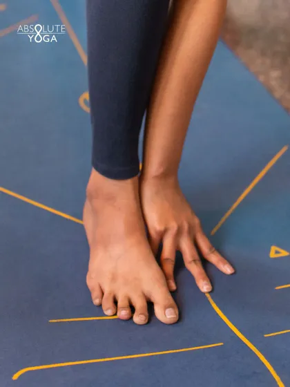 A close up of hands and feet on the mat. Yoga teaches you to connect with your inner divine, and sometimes that starts with the simple act of respecting your own body.