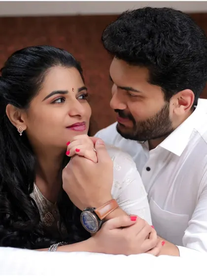 A close-up shot focusing on the couple's hands and expressions, highlighting their gentle connection.
