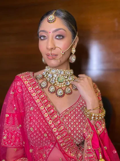 This shot highlights the intricate details of the nose ring and the stunning choker, with the makeup acting as a perfect, polished canvas.