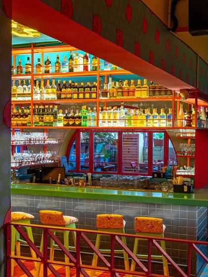 A view of The Fatty Bao's well-stocked bar from a different angle, showing the depth and color of the spirit collection. This is a classic bar photography shot that speaks to a wide selection and expert service.