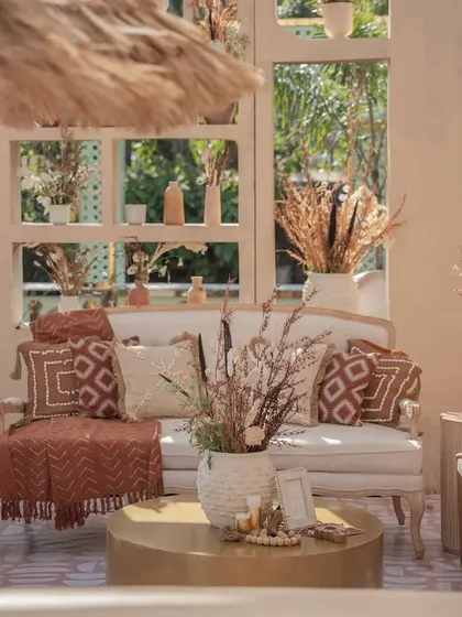 A close-up of the cozy seating area from the 'Desert Oasis' Haldi. I selected pillows and throws with geometric, earthy-toned patterns to perfectly match the rustic and elegant theme.