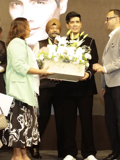 Another shot of me presenting the white floral hamper to Manish Malhotra, a moment of pride and joy.
