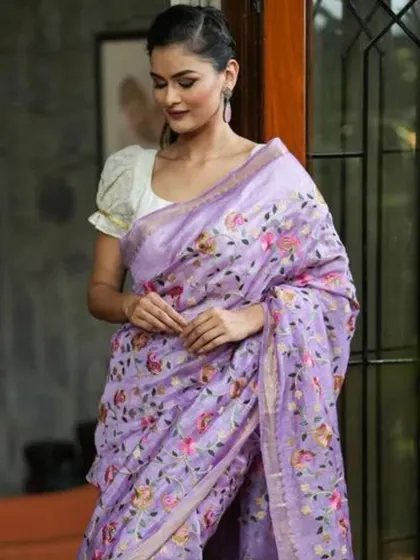 A lovely lavender linen saree with all-over floral embroidery. This is a feminine and romantic piece, perfect for garden parties or daytime events.