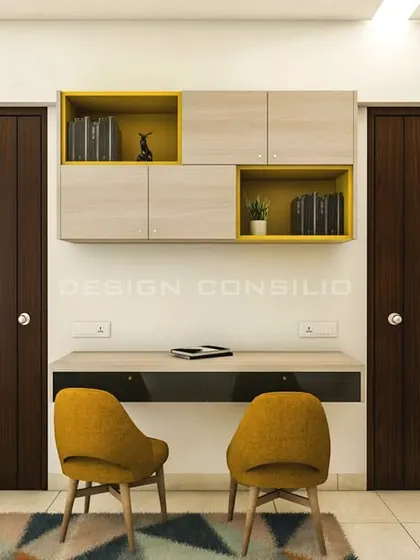 This image shows the study area in the shared bedroom. The floating desk and overhead cabinets in a cheerful yellow and light wood finish provide a dedicated space for two to study.