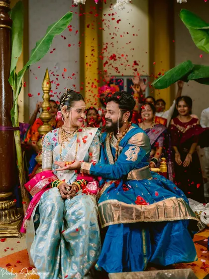 A joyful moment as the couple is showered with petals by their loved ones.