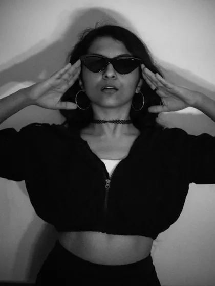 Another take on the 'black cat energy' theme, this time with a focus on framing the face. The monochrome tones and sharp sunglasses create a classic, cool look.
