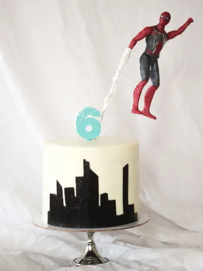 A gravity-defying Spiderman cake for the cutest little fan! I designed this to look like Spidey is swinging right over the city skyline. Superhero cakes are some of my favorites to make.